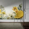 A room with a wall featuring the Golden Petals Elegance Mural, adorned with yellow and green leaves, complemented by a mustard-yellow velvet chair with metal legs on a gray area rug. A white door with a gold handle is visible on the right side of the image.